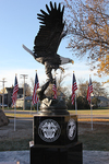 The bronze eagle statue sits atop a piece of granite which has been engraved with the logos of each of the U.S. military branches.